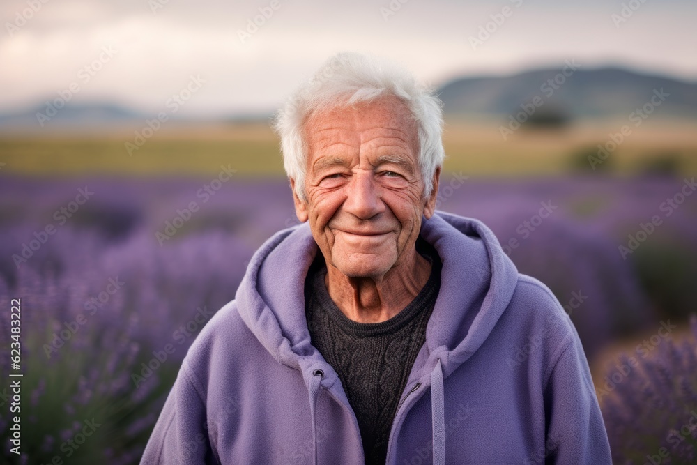 Environmental portrait photography of a satisfied old man wearing a comfortable hoodie against a lavender field background. With generative AI technology