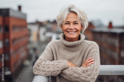 Studio portrait photography of a glad mature woman wearing a cozy sweater against a rooftop terrace background. With generative AI technology