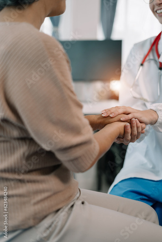 Female doctors shake hands with patients encouraging each other To offer love, concern, and encouragement while checking the patient's health. Concept Health care and Social Security