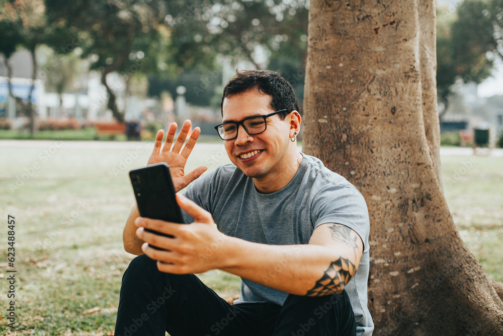 Portrait photography of a young man in video call from his phone. Concept of people, communications and technology. Portrait photography of a young man in video call from his phone. Concept of people, communications and technology.