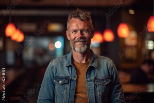 Medium shot portrait photography of a grinning mature boy wearing a denim jacket against a lively sports bar background. With generative AI technology