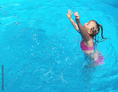 Little Girl Playing in a Swimming Pool - Pulling the Water Up - Water Splash