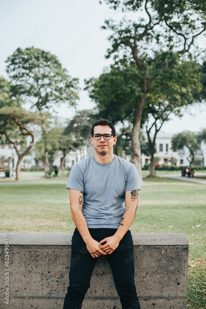 portrait of young man with glasses smiling in a park. Concept of people and mental health. portrait of young man with glasses smiling in a park. Concept of people and mental health.