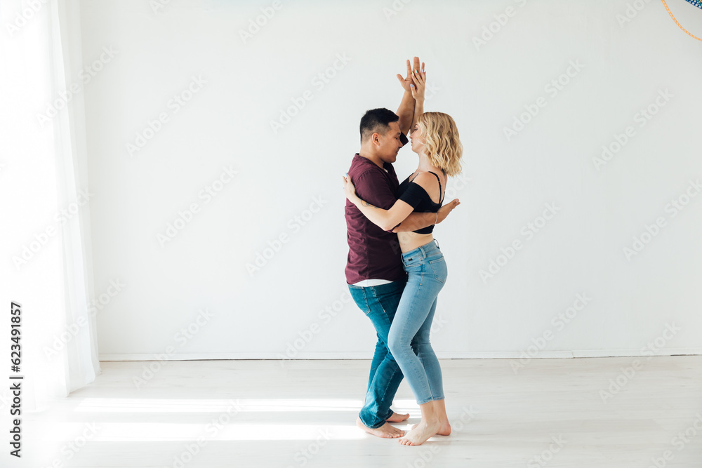 a man and a woman dance in the hall of the studio kizomba bachata Latina a man and a woman dance in the hall of the studio kizomba bachata Latina