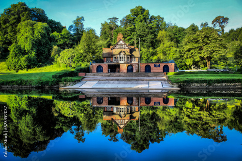 Obraz na plátně View of a boathouse across a lake