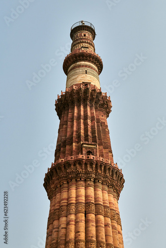 Qutb Minar minaret tower part Qutb complex in South Delhi, India, big red sandstone minaret tower landmark popular touristic spot in New Delhi, ancient indian architecture of tallest brick minaret photo