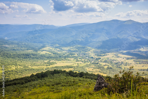 Beautiful view from the Ukrainian Polonynian Beskids to the mountains and valleys. Rocky peaks of the Ukrainian Carpathians in summer. Water-making ridge in the Carpathians, Carpathian mountains