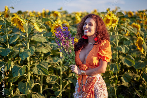 portrait of a beautiful woman near a field of sunflowers on a sunny day at sunset.