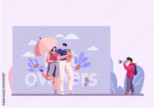 Professional photographer makes a photo of happy cat owners. Couple in love order the photosession in the park with their new cat. Boy uses camera to capture young people and their new red cat