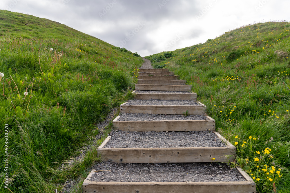 Trail of steps leading up the hill to Sugandisey Island Lighthouse in Stykkisholmur Iceland