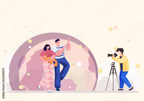 Cameraman provides professional pets photography services in the park. Evening photo session of the couple with their cat with the moon on the backgroung. Couple in love order the shooting their cat