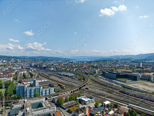 Aerial view of City of Zürich industrial district with railway viaduct and Lake Zurich in the background on a sunny spring day. Photo taken May 28th, 2023, Zurich, Switzerland. © Michael Derrer Fuchs