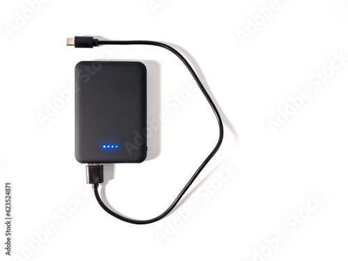 Power bank for charging mobile devices on a white background. Smartphone charger with power supply. External battery for mobile devices.