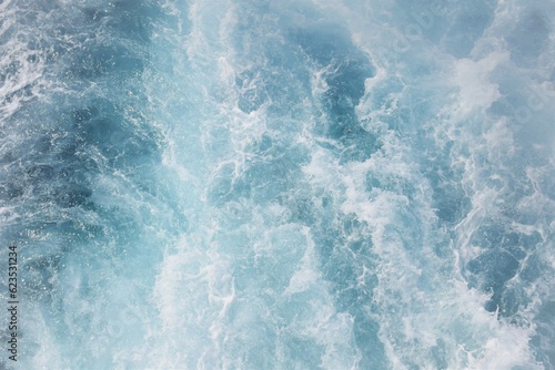 Image of sea water waves and foam. Top view vintage background image.