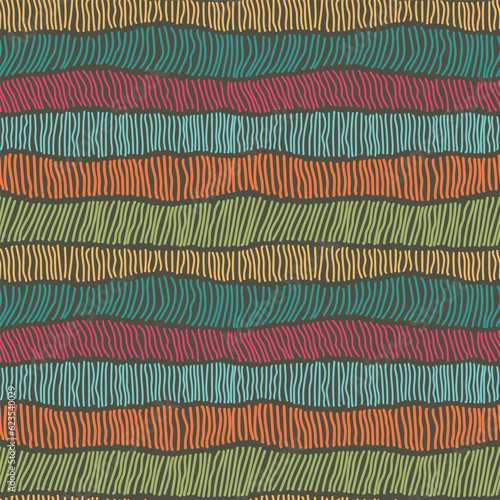 Endless pattern of colorful hand drawn vertical stripes arranged in uneven casual rows against dark brown background. Vivid boho vector seamless pattern for textiles and interior.