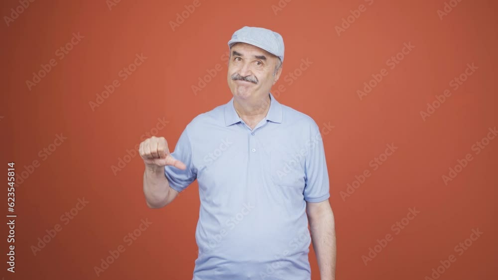 Old man looking at camera with a negative expression. Old man looking at camera with a negative expression.