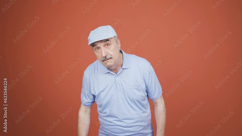 Old man looking at camera with curious expression. Old man looking at camera with curious expression.