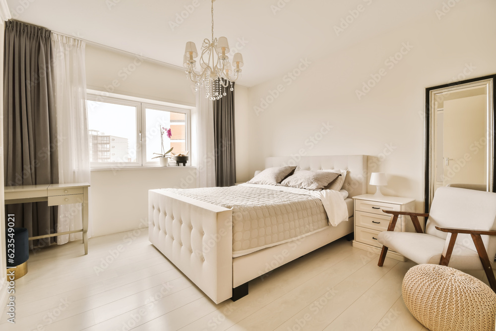 a bedroom with a bed, chair and mirror on the wall in front of the window looking out onto the street a bedroom with a bed, chair and mirror on the wall in front of the window looking out onto the street