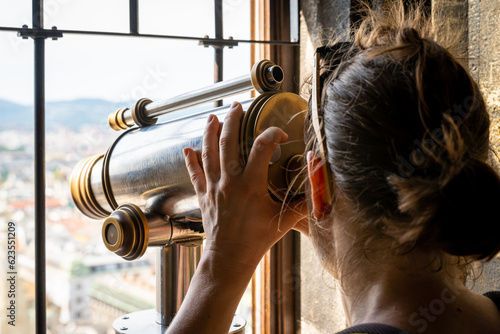 Canvas Print Tourist looks through the telescope from the top of the church tower, selective