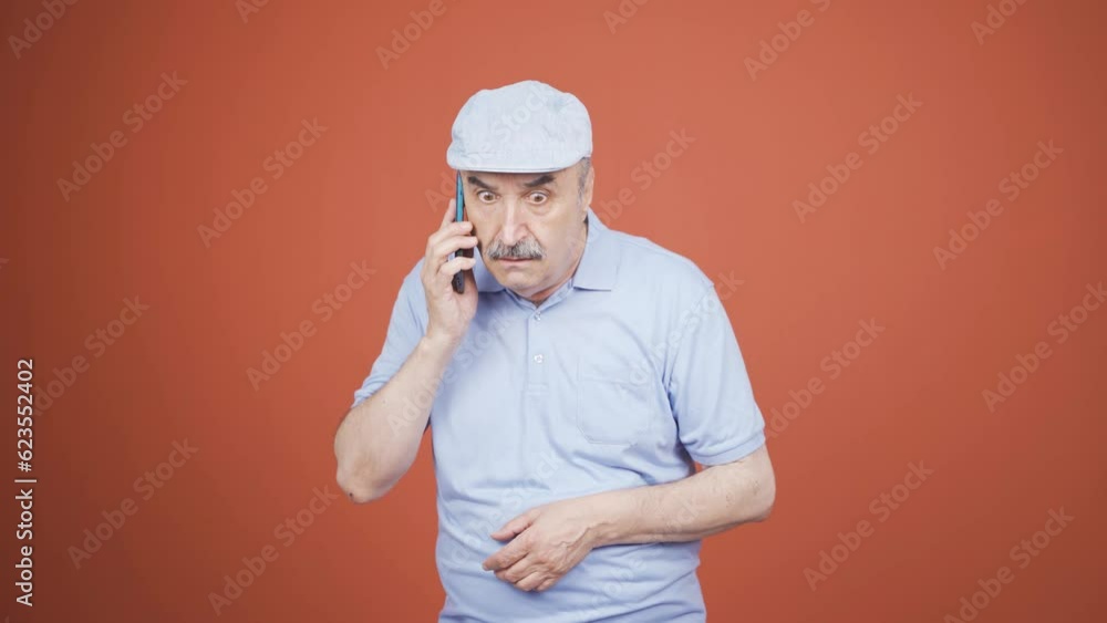 Old man getting bad news on the phone gets upset. Old man getting bad news on the phone gets upset.