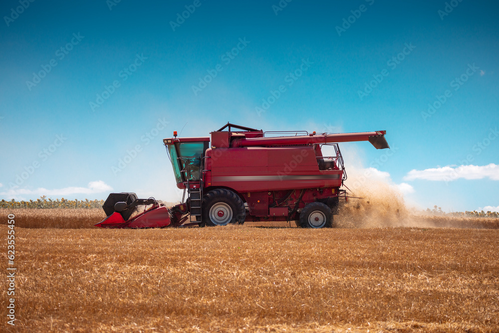 Combine harvester machine working in a wheat field Combine harvester machine working in a wheat field