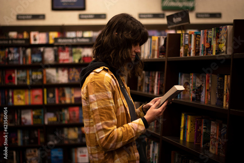 Girl Reading a Book Cover Among Bookshelves