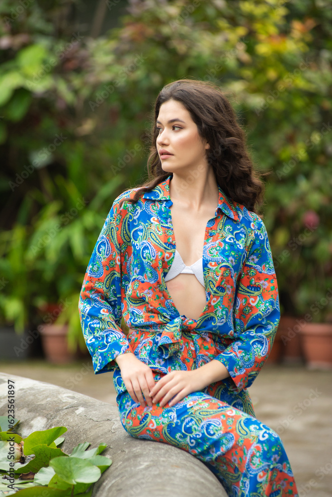 Beautiful woman relaxing and posing on jungle resort near tropical trees Beautiful woman relaxing and posing on jungle resort near tropical trees