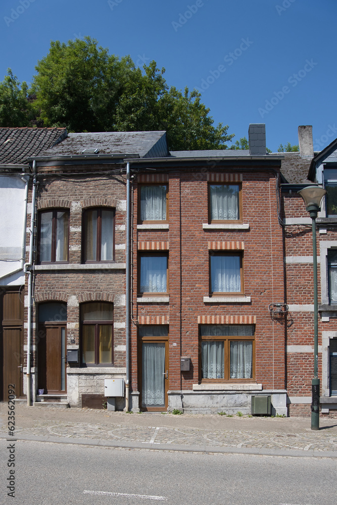 narrow house in a row of houses in Belgium along the street