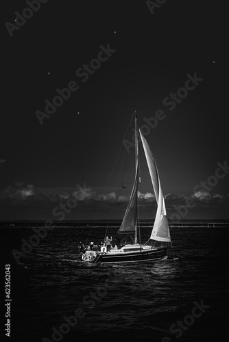 sailboat at night,single sailing yacht at night under the starry sky