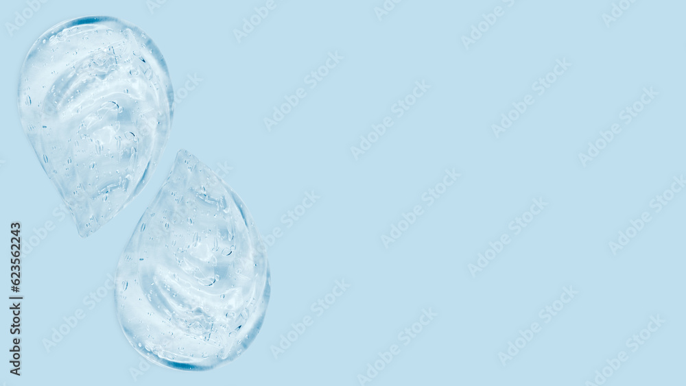 Drops and smears of a transparent gel or serum on a blue background. Banner with empty space for advertising. Drops and smears of a transparent gel or serum on a blue background. Banner with empty space for advertising.