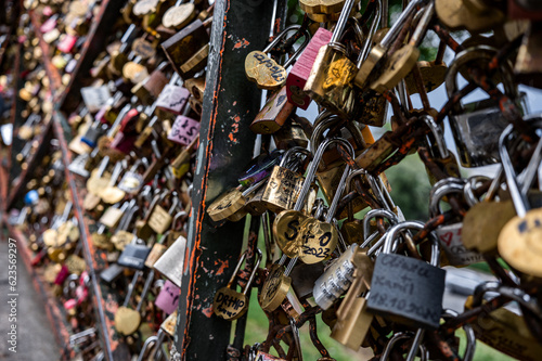 Close up of padlocks (love locks) on fences in PARIS, FRANCE - July 2023.