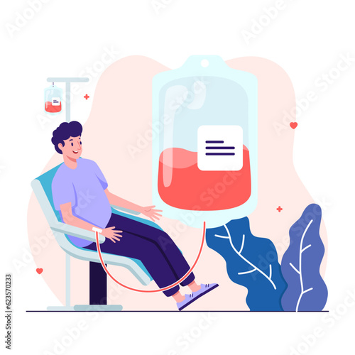 Man in a chair donating his blood into a blood bag