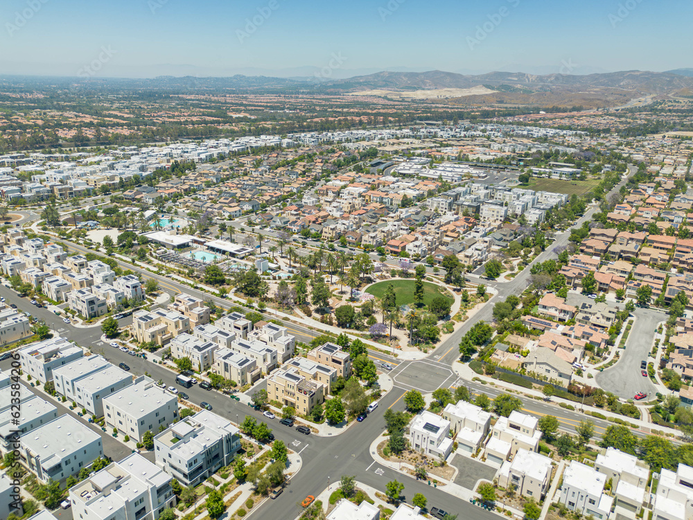 Irvine, California - July 1, 2023: Aerial drone photo above Irvine Great Park Village in Irvine for new townhouses, townhomes, homes, houses, with Great Park Blvd, Parasol Park, Single Dogs Trail, Bea