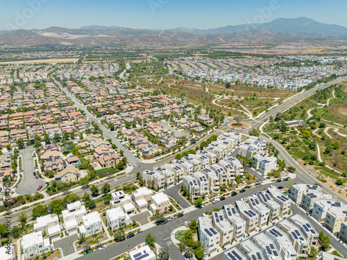 Irvine  California - July 1  2023  Aerial drone photo above Irvine Great Park Village in Irvine for new townhouses  townhomes  homes  houses  with Great Park Blvd  Parasol Park  Single Dogs Trail  Bea