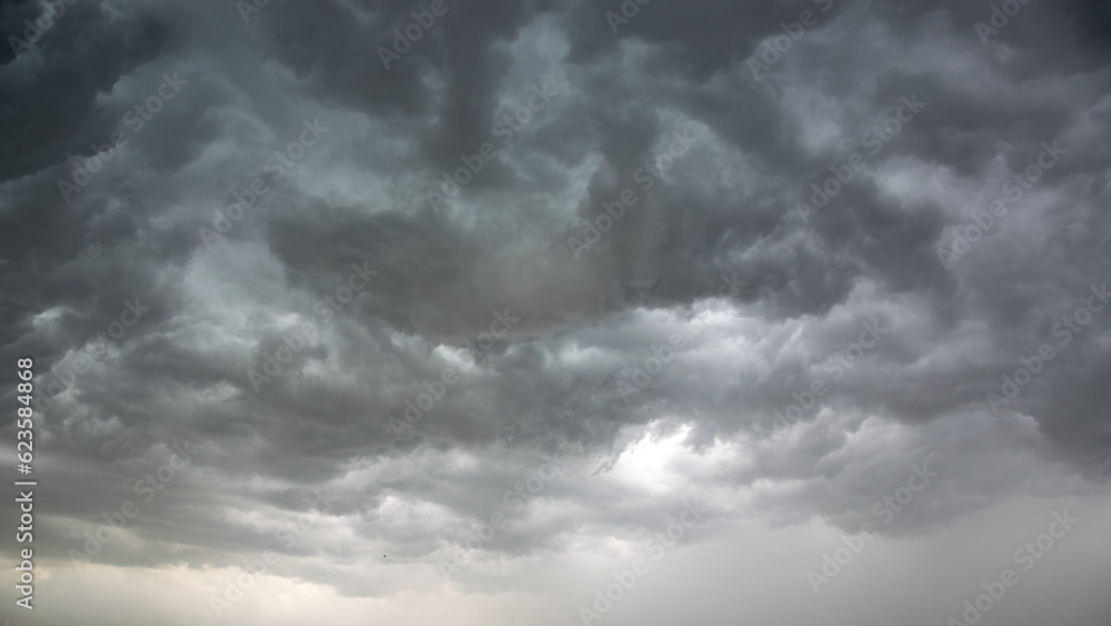Obraz premium Dark storm clouds before a thunder-storm. Panoramic image.