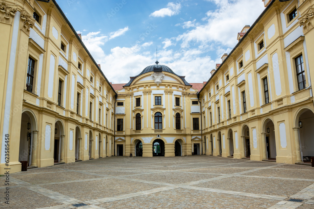 Courtyard of the Slavkov (Austerlitz) castle with columns and windows and stone paving on the ground, Czech Republic.