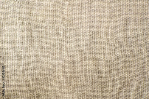 Warm beige linen fabric background with copy space
