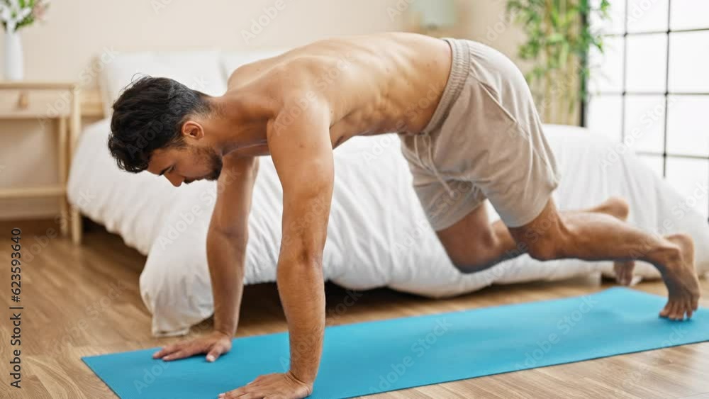 Young hispanic man training core exercise at bedroom Young hispanic man training core exercise at bedroom