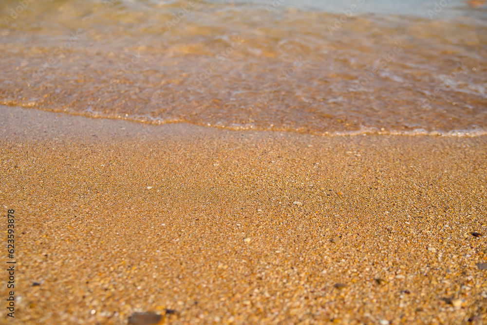 Golden sand at the beach, with soft touch of a calm waves Golden sand at the beach, with soft touch of a calm waves