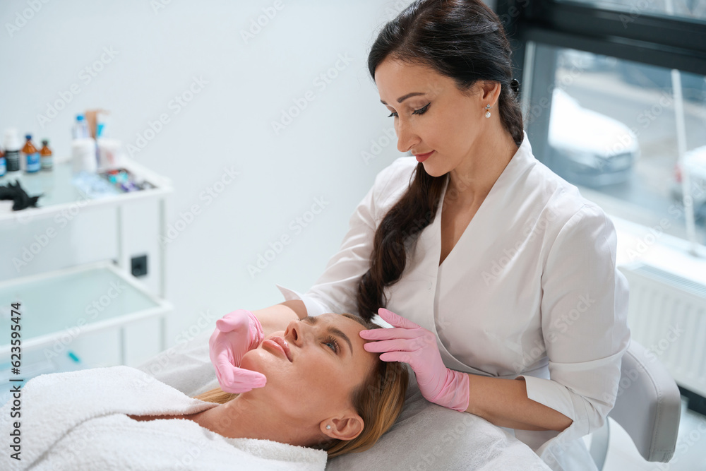 Beautiful female is located on a cosmetology couch Beautiful female is located on a cosmetology couch