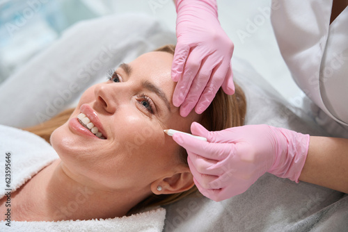 Smiling woman at a consultation in a cosmetology clinic