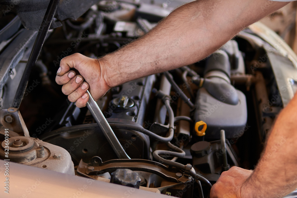 Auto mechanic working on car engine in mechanics garage. Repair service. authentic close-up shot
Auto mechanic working on car engine in mechanics garage. Repair service. authentic close-up shot