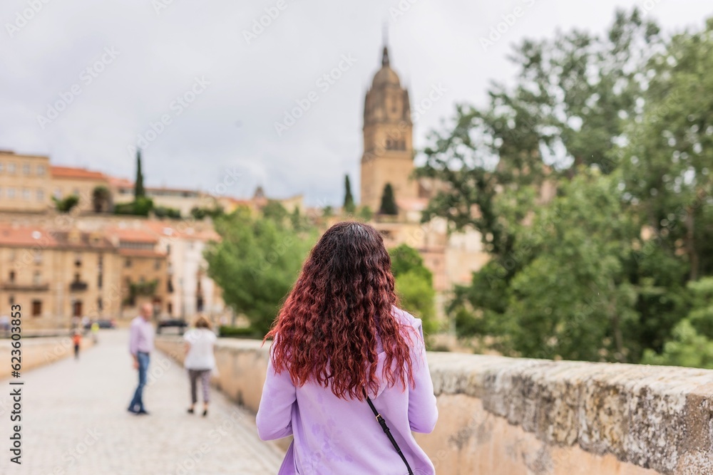 Unrecognizable female back view travel vacation, explore city of Spain. Salamanca tourist