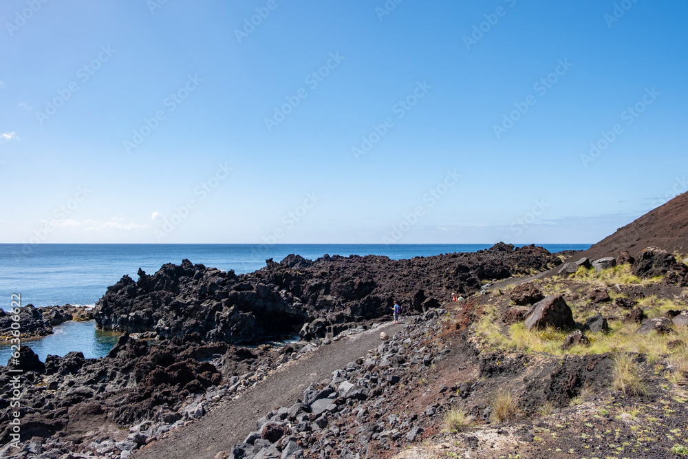 Landscape view in Ferraria on a beautiful summer day. Thermal waters at Ponta da Ferraria, thermal waters in the sea and natural hot water pools. Sao Miguel island in Azores Landscape view in Ferraria on a beautiful summer day. Thermal waters at Ponta da Ferraria, thermal waters in the sea and natural hot water pools. Sao Miguel island in Azores