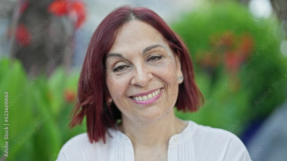 Middle age woman smiling confident standing at park Middle age woman smiling confident standing at park