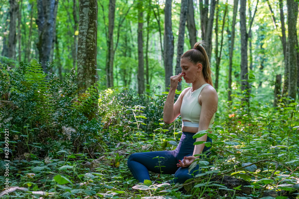 woman doing breath exercises in the forest pranayama woman doing breath exercises in the forest pranayama