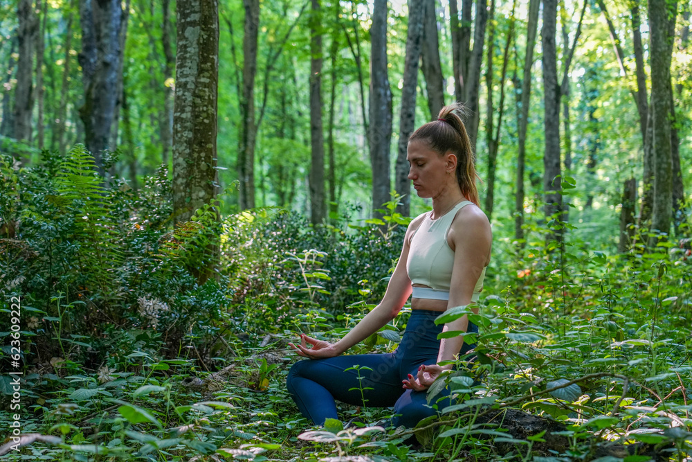 woman doing yoga in the forest woman doing yoga in the forest