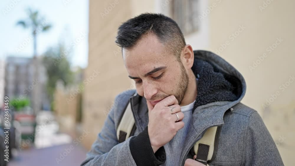 Hispanic man standing with doubt expression at street Hispanic man standing with doubt expression at street