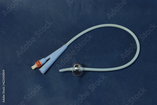 Foley catheter in a dark blue background with a insuflated balloon. photo