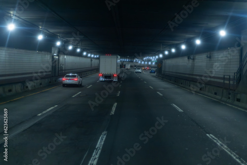 A car that is driving down a tunnel with a truck on the back. © KirKam